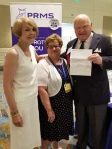 PRMS endows the GAP child psychiatry fellowship; pictured is PRMS Executive Vice President Jackie Palumbo presenting GAP President John Looney along with Susan Looney a letter of agreement for the PRMS endowment.